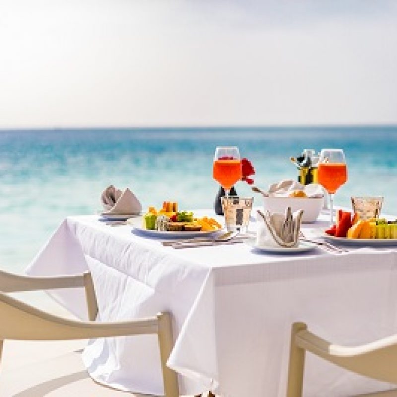 Luxury breakfast food on white table, with beautiful tropical se